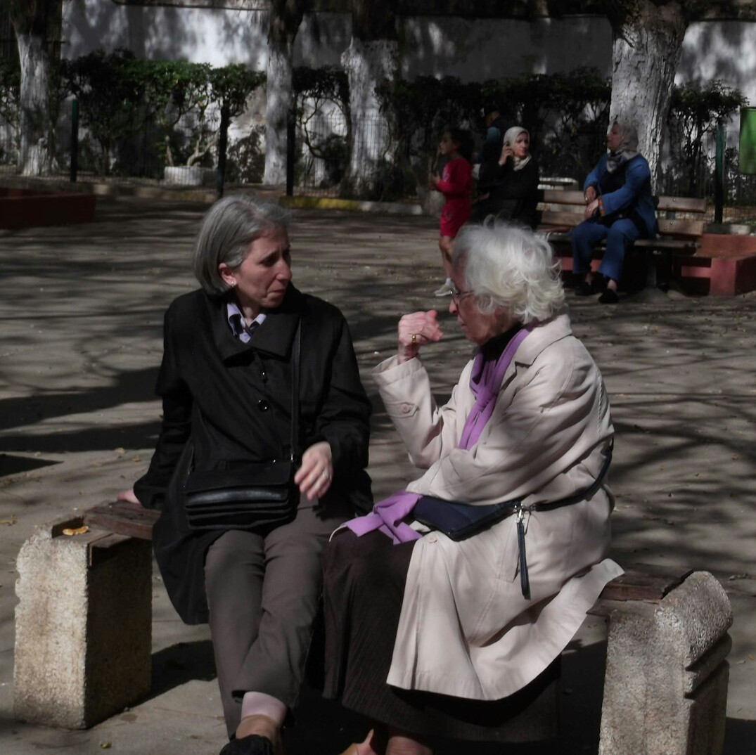 senior and young person talking outdoors